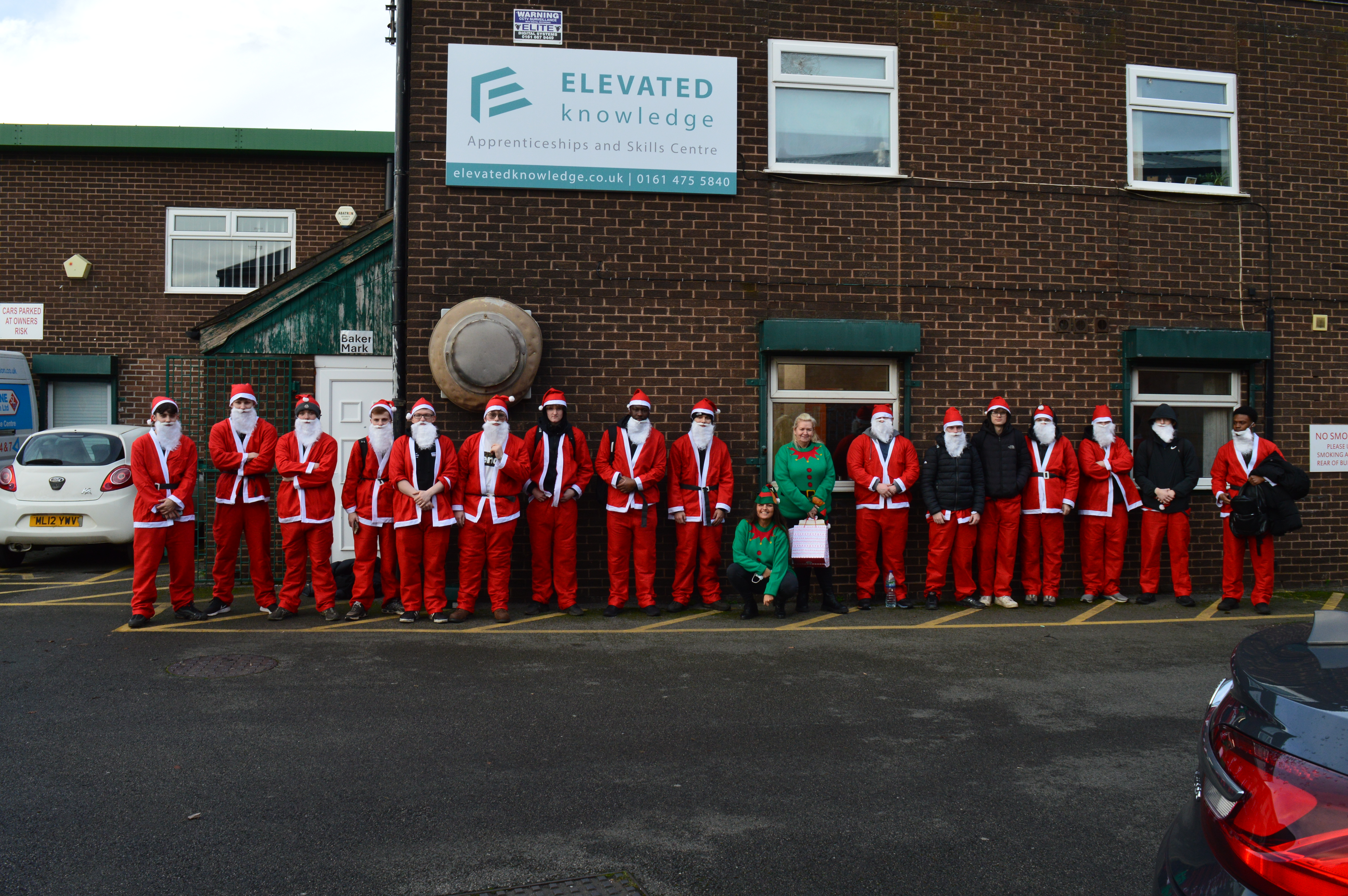 Elevated Knowledge Apprentices dressed as Santa Claus ready for Santa Dash 2025